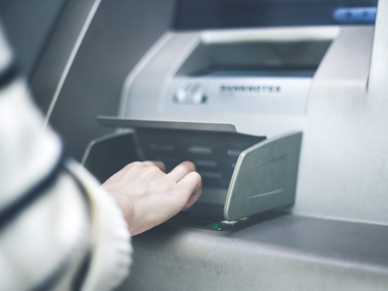 Woman using cash machine-ATM,close up view